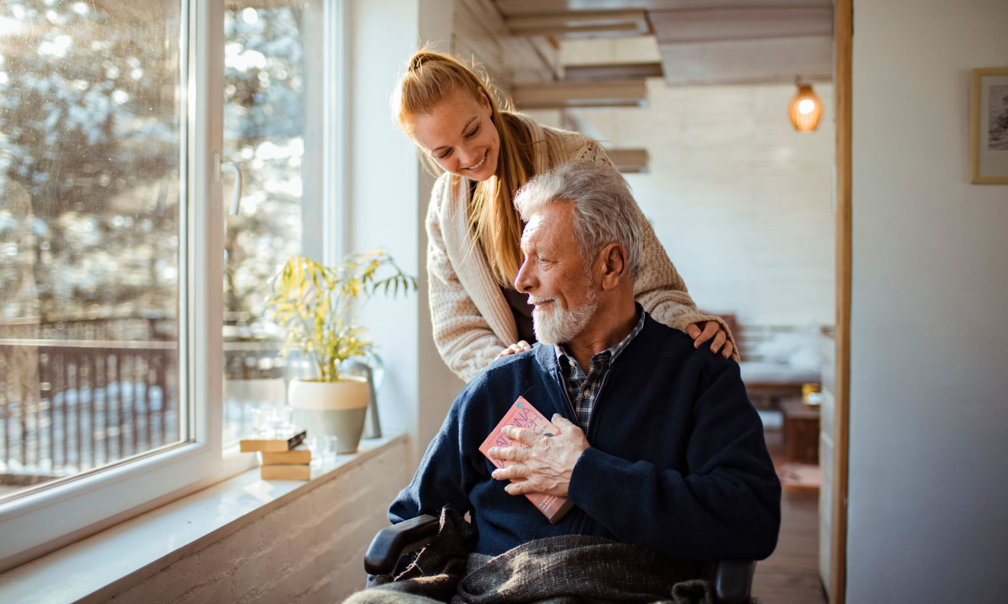 Caregiver assisting a senior gentleman at Broadwell Senior Living in Kearney, Nebraska