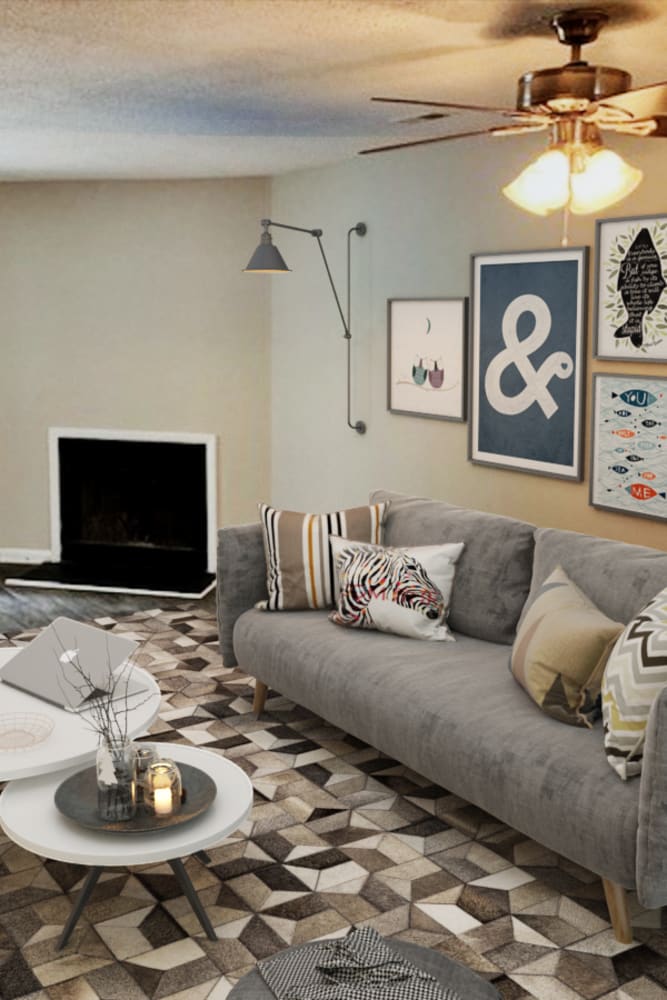 Comfortable living room with wood-style flooring and a fireplace at Amber Oaks in Durham, North Carolina