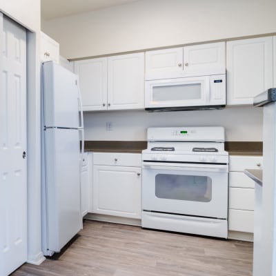 White cabinets and appliances in a kitchen at Wire Mountain II in Oceanside, California