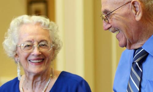 Two residents smiling at a Merrill Gardens community.