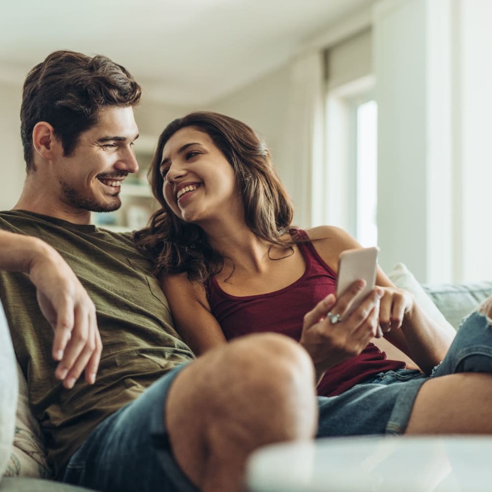 Happy residents sit on a sofa in their apartment at LaCabreah, Brownsburg, Indiana