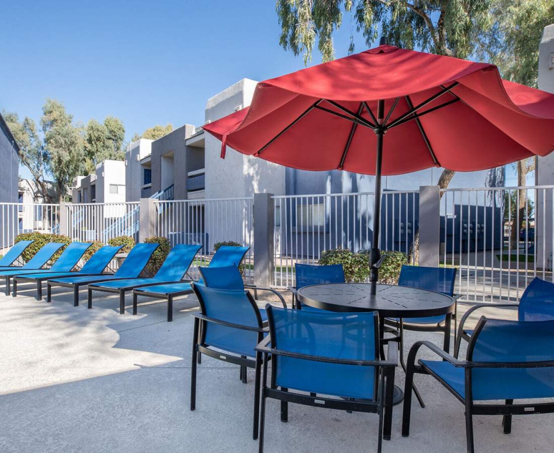 Lounge chairs by the community pool at 544 Southern Apartments in Mesa, Arizona