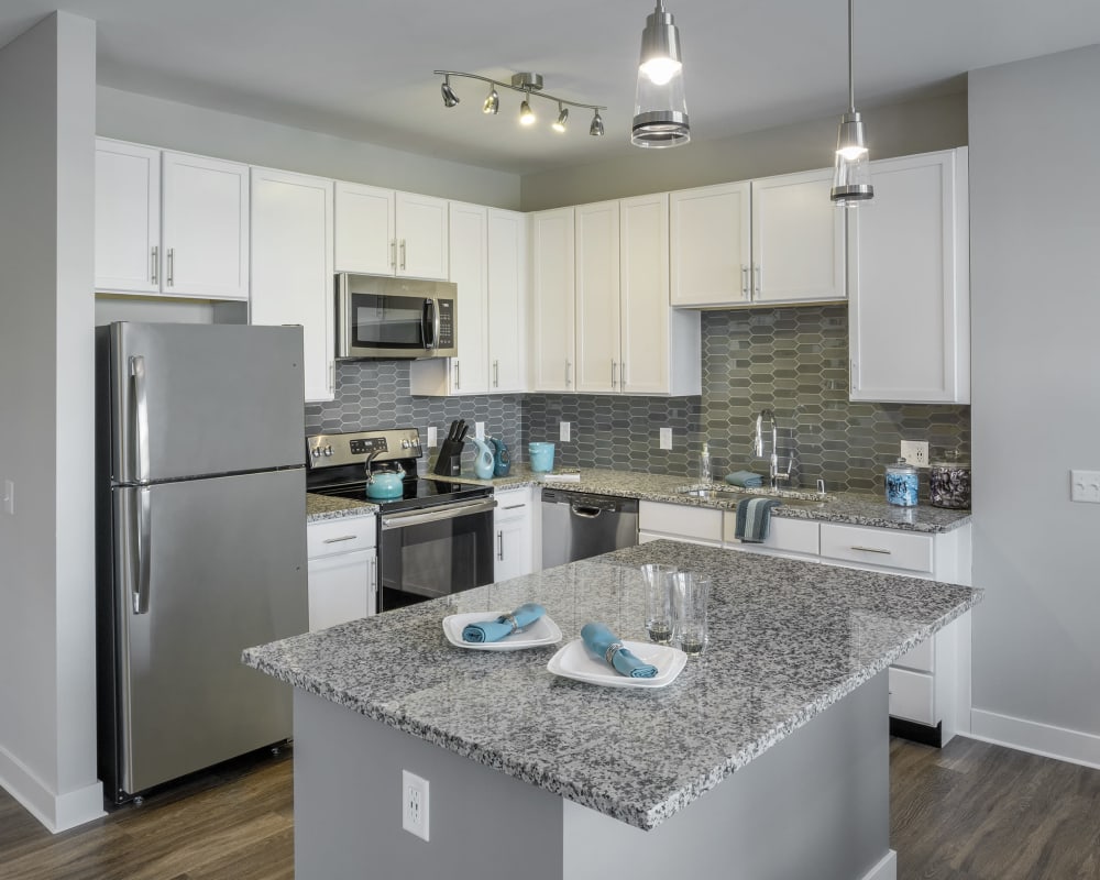 Gorgeous kitchen with granite countertops and stainless steel appliances at The Residences at Crosstree in Freeport, Maine