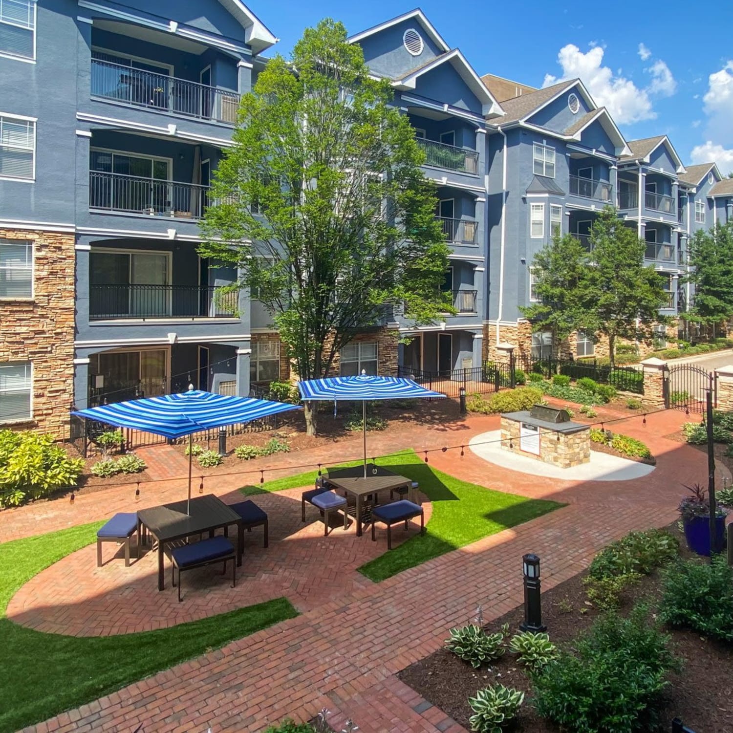 Exterior of an apartment building and the courtyard at Aster Buckhead in Atlanta, Georgia