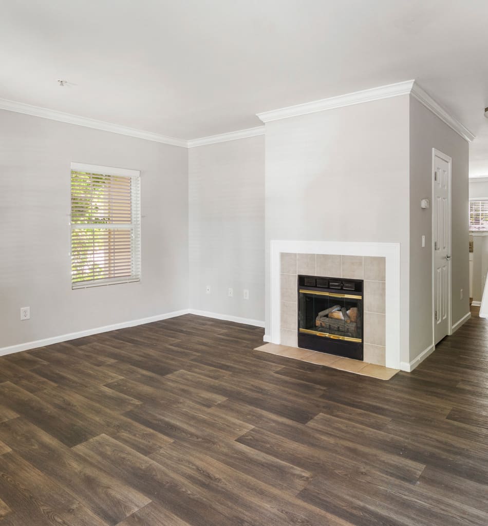 Open-concept living area with a fireplace in a model home at Sofi at Salem Station in Salem, Massachusetts