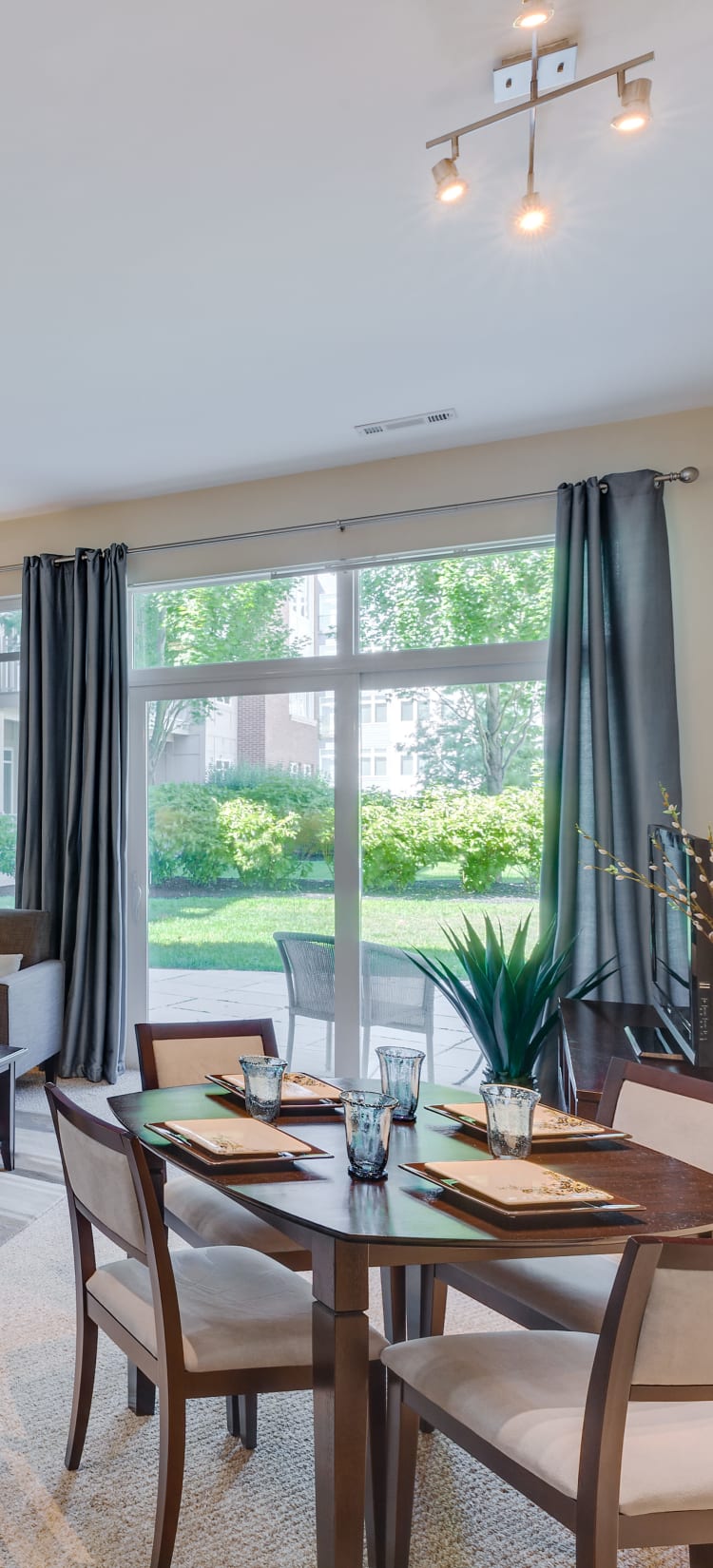 Modern living room with round table at Arcadia at Rivers Edge in Medford, Massachusetts