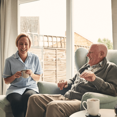 Staff and resident bonding together over coffee at Milestone Retirement Communities 