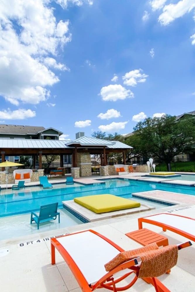 Lounge chairs by the pool at Esperanza in San Antonio, Texas