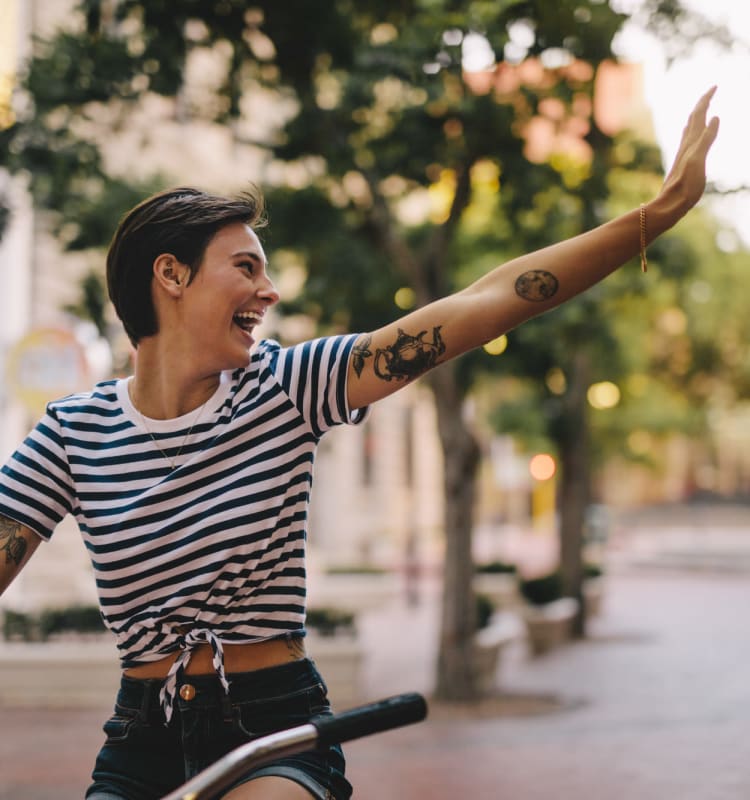 Resident enjoying a bike ride through town near New Barn Apartments in Miami Lakes, Florida