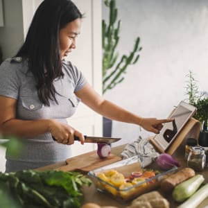 Resident preparing a meal in their new home at Buffalo Ridge in Princeton, Texas