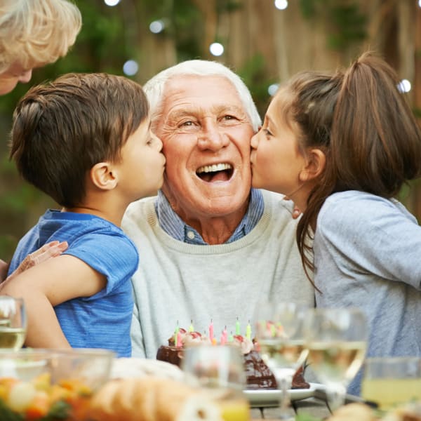 Resident spending time with his grandchildren at Pacifica Senior Living Palm Springs in Palm Springs, California
