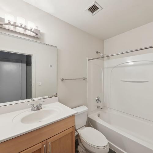 Bright bathroom with bathtub at Stadium Loft Apartments in Saint Louis, Missouri