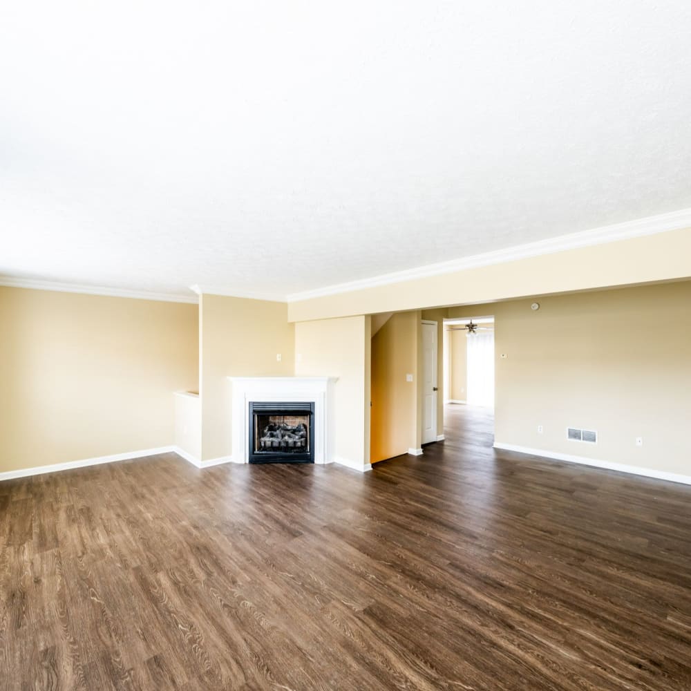 Spacious apartment with wood-style flooring and fireplace at The Estates at Seven Fields, Seven Fields, Pennsylvania