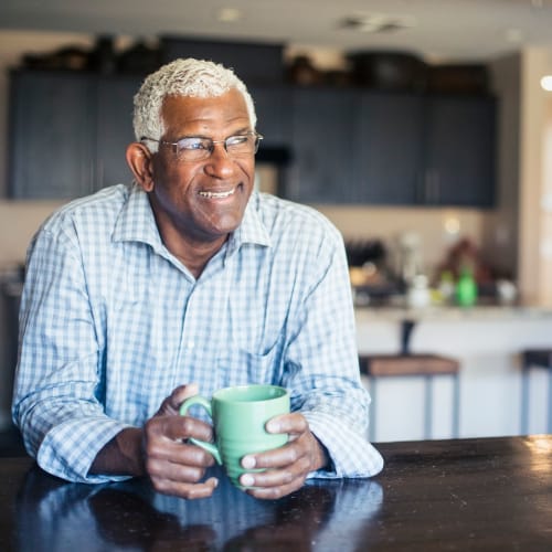 A resident holding his cup at Covenant Trace in Newport News, Virginia