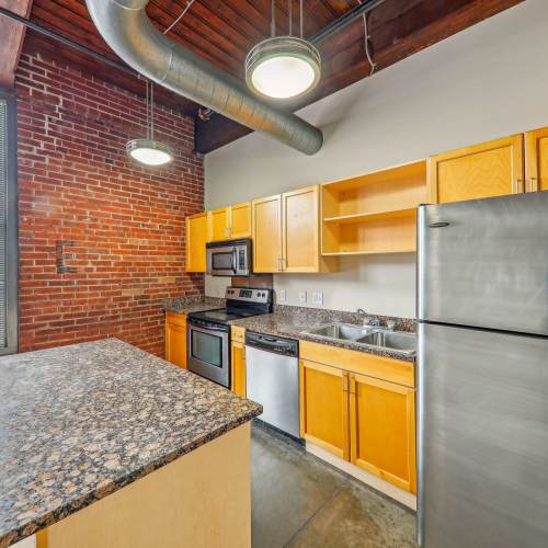 Kitchen with stainless-steel appliances at Stadium Loft Apartments in Saint Louis, Missouri