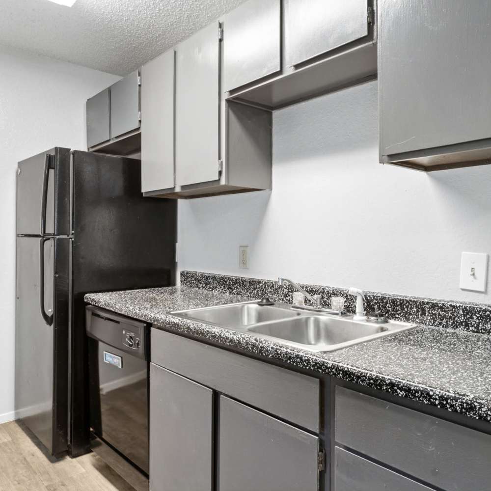 Granite countertops and black appliances at Arbors of Taylor in Taylor, Texas