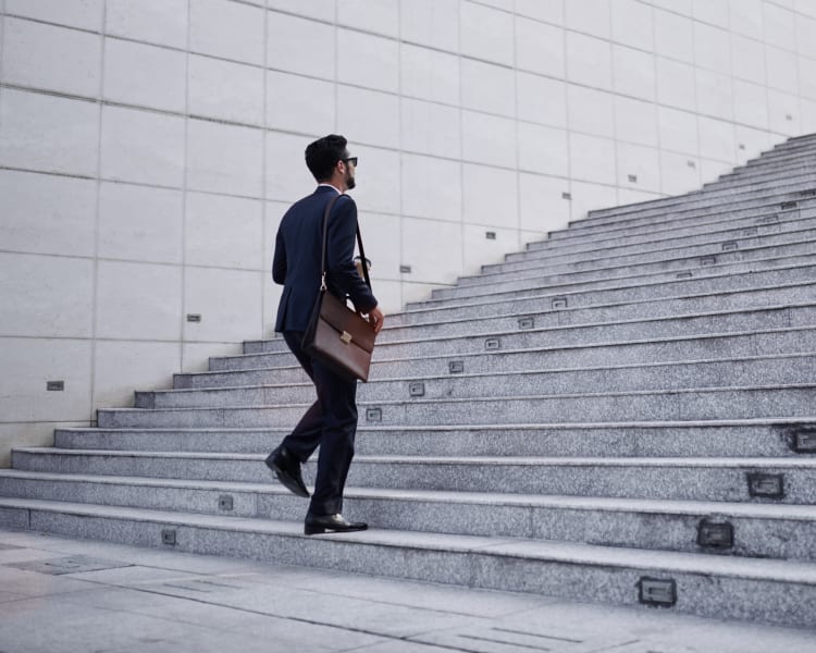 Resident walking up the steps to his downtown office near Sofi Warner Center in Woodland Hills, California