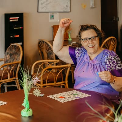 Resident playing board game at 6th Ave Senior Living in Tacoma, Washington