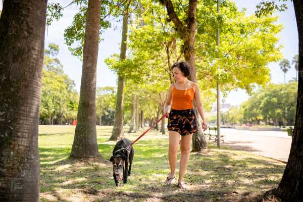 Resident with her dog in dog park at 7 at Seven Mile Creek in Nashville, Tennessee
