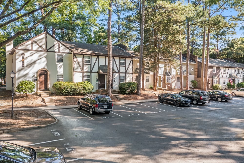 Apartment building with plenty of parking that's well landscaped at Chelsea at Lee Hall in Newport News, Virginia
