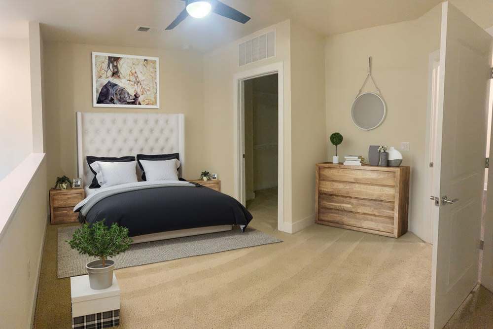 Bedroom with plush carpeting, ceiling fan and access to closet at The Julien in Charlotte, North Carolina