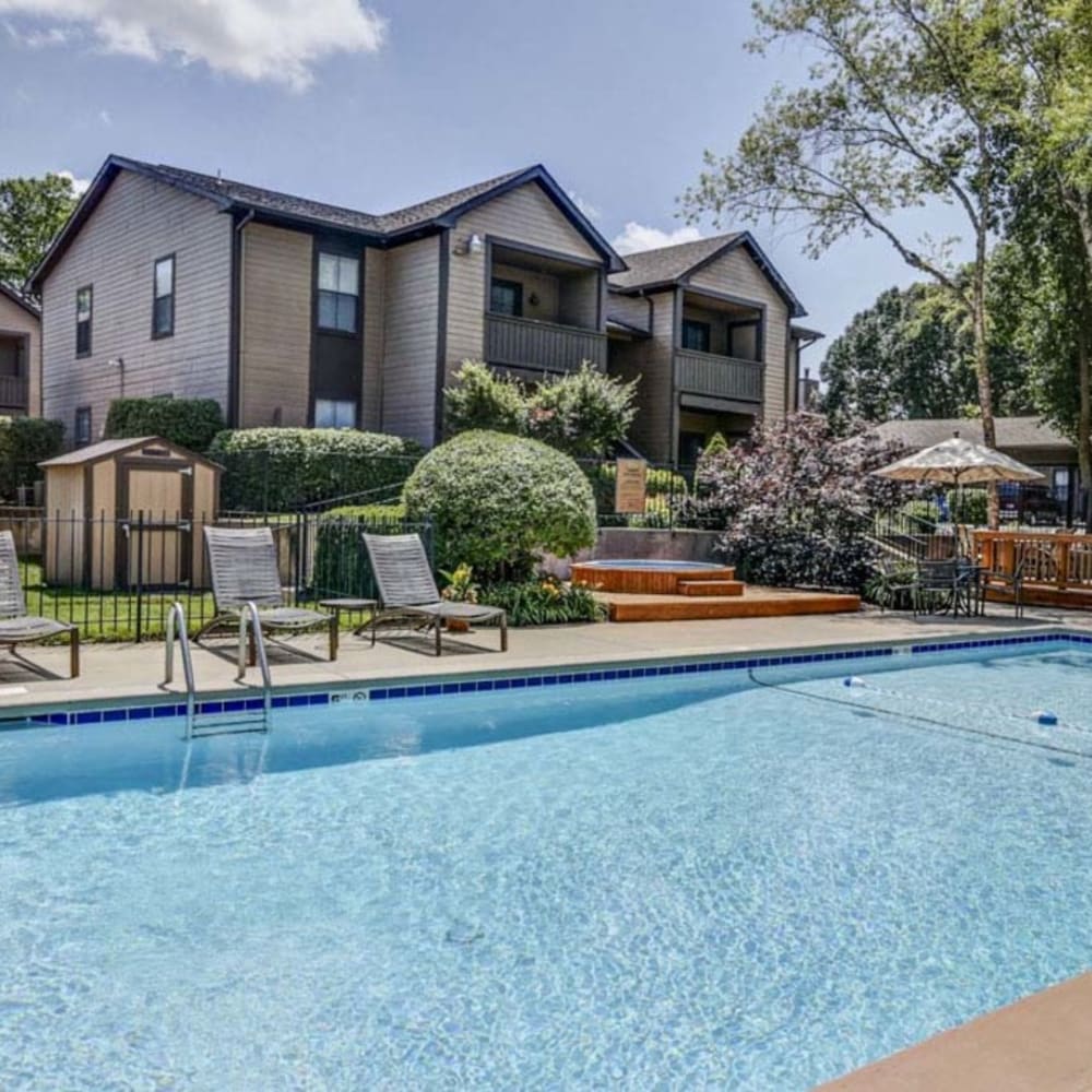 Resident buildings with maintained landscaping at Springhill Apartments in Overland Park, Kansas