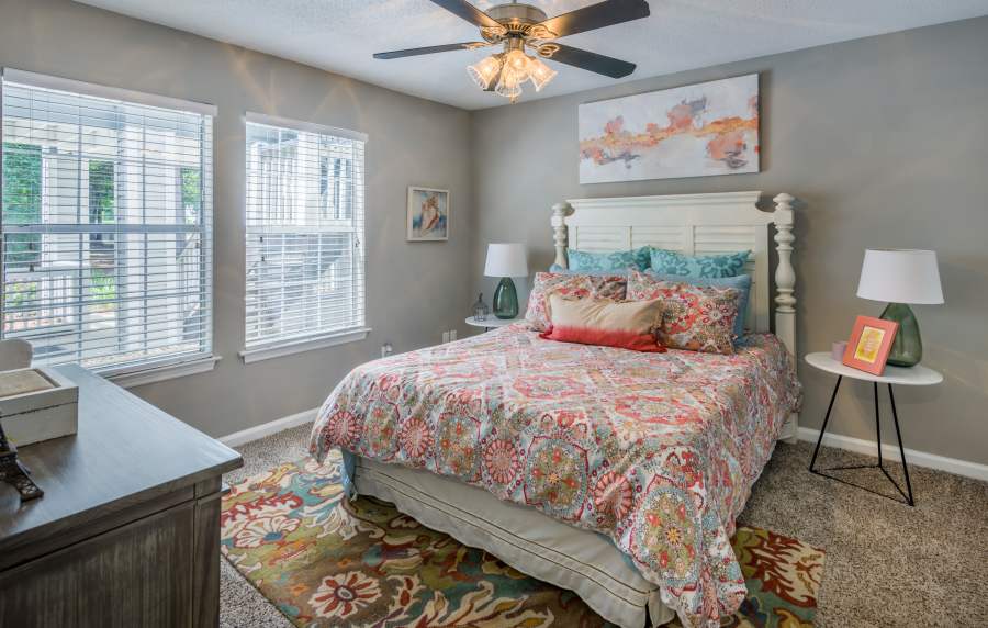 Colorful bedspread on a bed with pillows at Heron on the Bluffs in Savannah, Georgia
