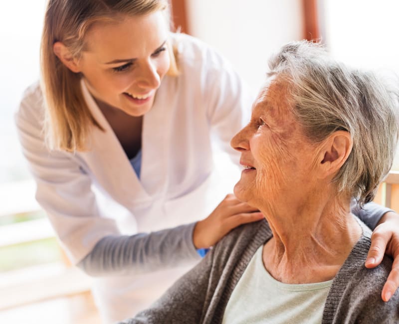 A caregiver helping a resident at The Sanctuary at St. Cloud in St Cloud, Minnesota