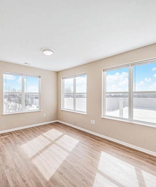Spacious living area with windows at Breton Grove II in Grand Rapids, Michigan