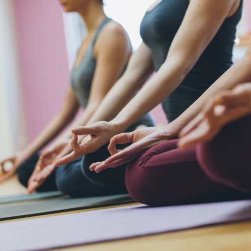 Women practicing yoga in a serene studio with mats and calming atmosphere at Rincon Apartments in McAllen, Texas