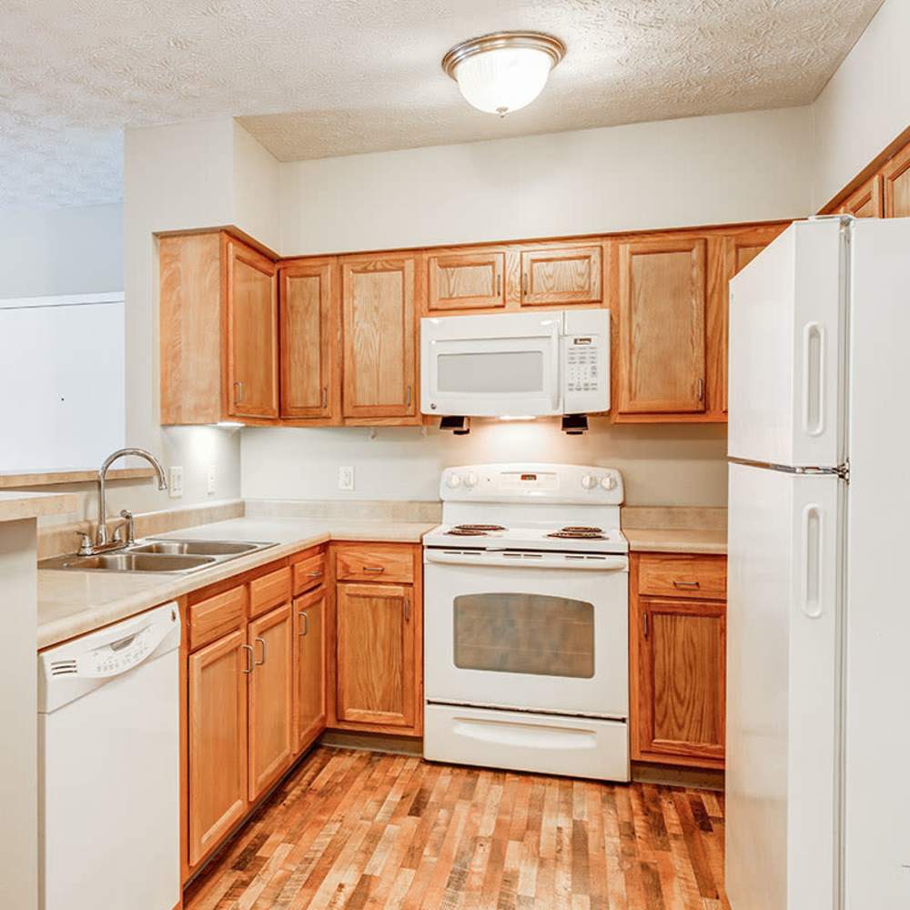 Kitchen with white stove, oven, and microwave at Autumn Run in Millersburg, Ohio