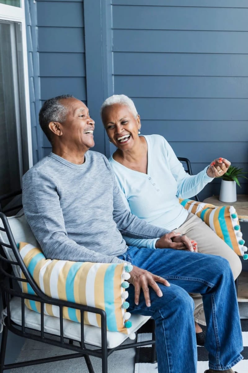 Resident couple hanging out on a porch at Carriage Inn Katy in Katy, Texas