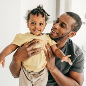 Resident and toddler smiling at Stonegate Apartments in Mckinney, Texas