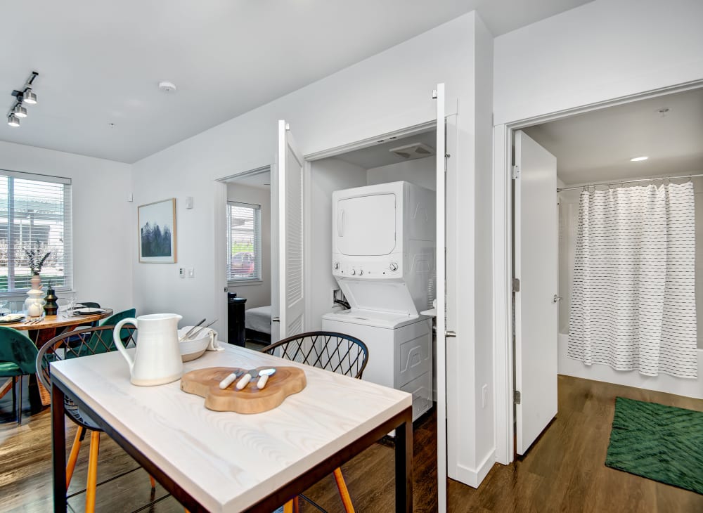 Model Living Room and dining room with washer and dryer at Ambrose in Bremerton, Washington