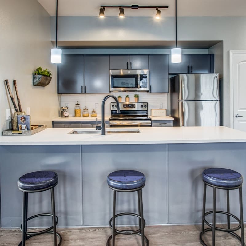 Breakfast bar with stools at Cleo Luxury Apartments in Dallas, Texas