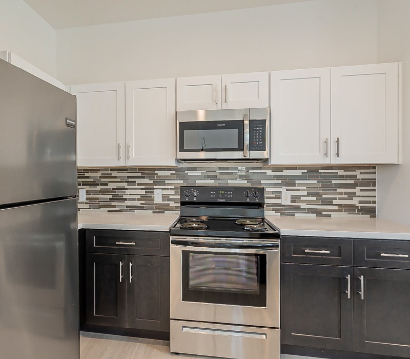 Model kitchen with stainless-steel appliances at Main Street Lofts at Verrado in Buckeye, Arizona