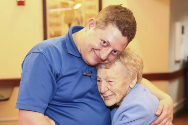 Resident hugging staff member   at Dougherty Ferry in Valley Park, MO