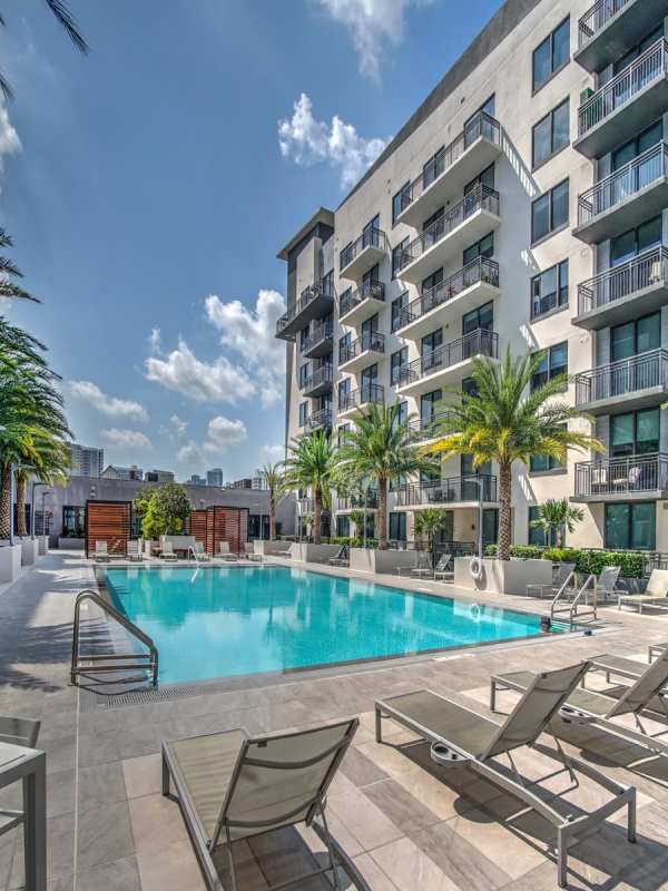 A sparking swimming pool surrounded by lounge chairs at EON Squared in Fort Lauderdale, Florida