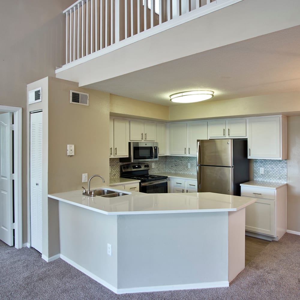 A kitchen with a breakfast bar at Calais Park Apartments in St Petersburg, Florida