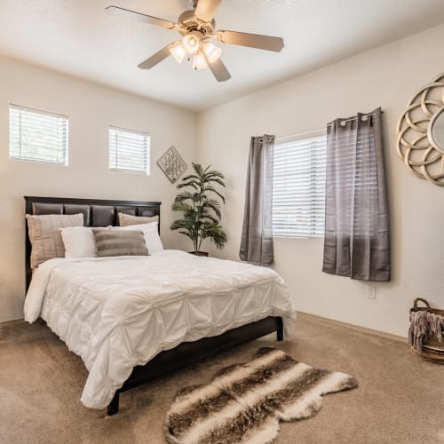 Apartment bedroom with a ceiling fan at Del Mar Apartments in Phoenix, Arizona