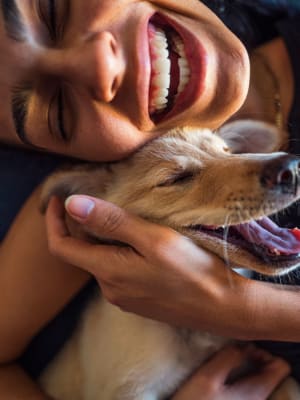 Resident hugging her puppy at Adirondack in Independence, Missouri