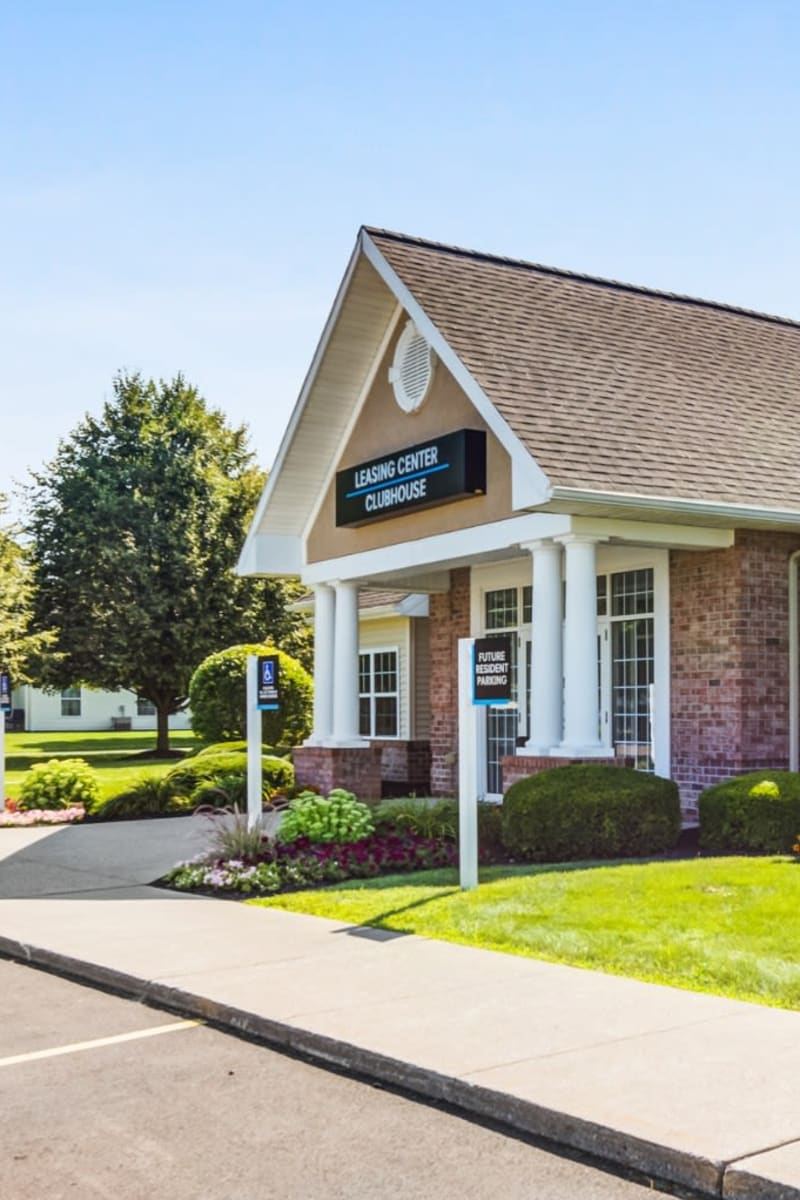 Exterior of Regency & Victor Villas Apartments on a sunny spring day in Victor, New York