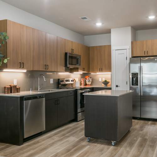 Well-equipped kitchen with island in a model home at Olympus Latitude in Albuquerque, New Mexico