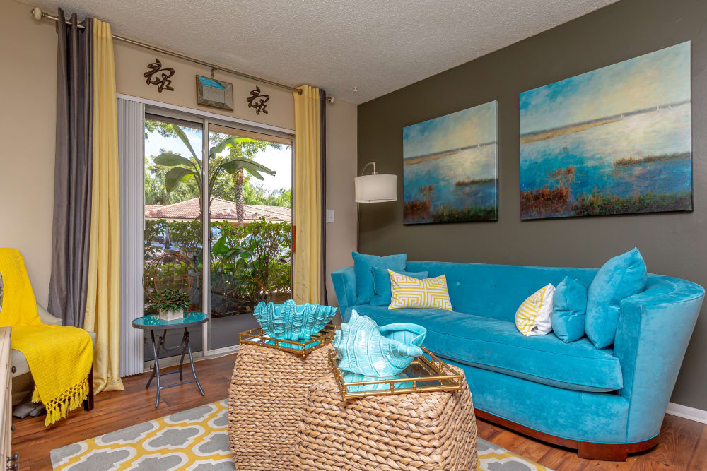 Sliding glass door floods this living room with natural light at Fairway View Apartments in Hialeah, Florida