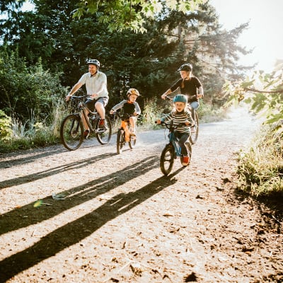 Family riding their bikes nearby Henley at The Rim in San Antonio, Texas