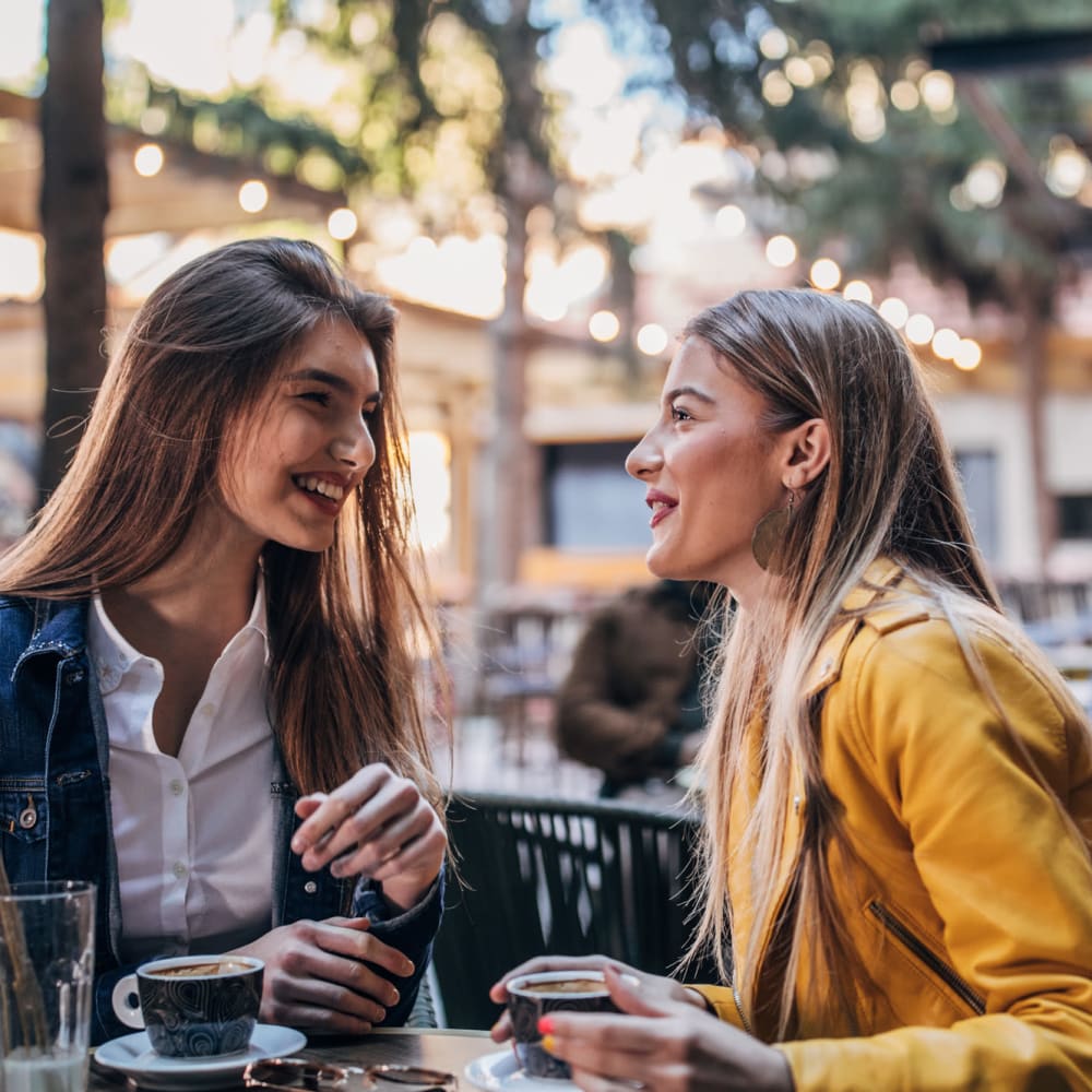 Friends catching up over coffee at their favorite café near Ellington Midtown in Atlanta, Georgia