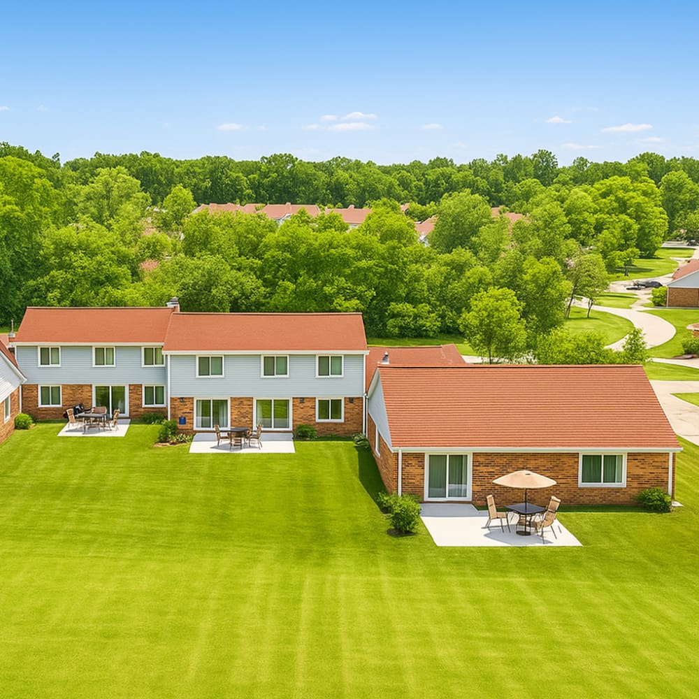 Spacious green lawns with patio seating at 83 West Townhomes in West Bloomfield Township, Michigan