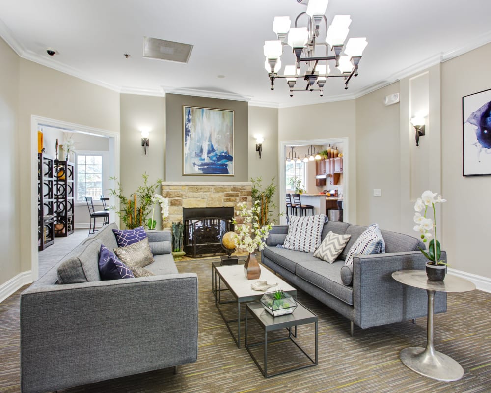 Sitting area in front of the fireplace in the resident clubhouse at The Gates of Deer Grove Apartment Homes in Palatine, Illinois