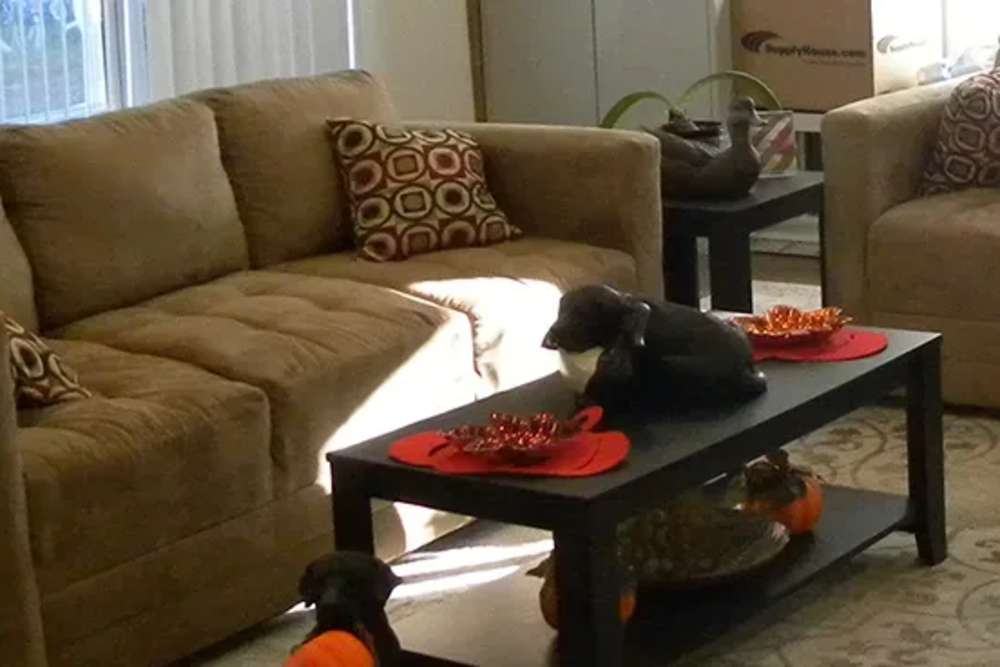 Spacious living room with couch and coffee table at Copper Hills Apartments in Houghton, Michigan,