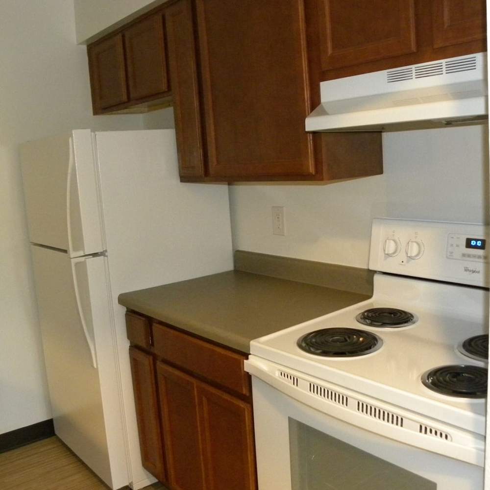 Kitchen with a refrigerator at Copper Hills Apartments in Houghton, Michigan